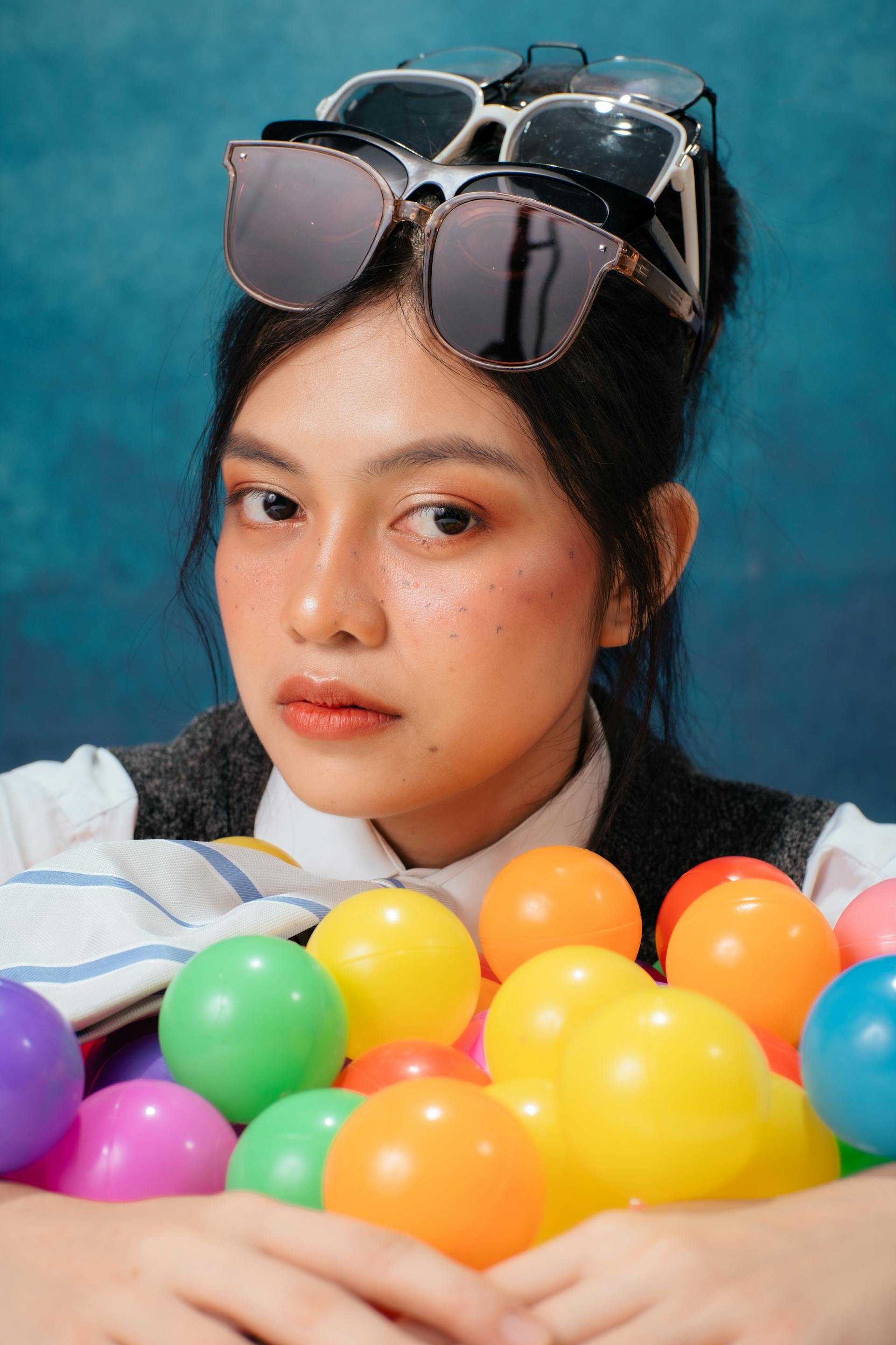 Photo by Cherry Ann Gonzales: https://www.pexels.com/photo/colorful-portrait-of-woman-with-sunglasses-and-balls-33819483/